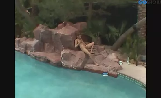 Girl with naked labia, cunt and clit gives blowjob at poolside while fingering herself